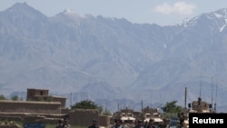 Police patrol near the site where a suicide bomber blew himself up in Bagram near the U.S. base on May 19.