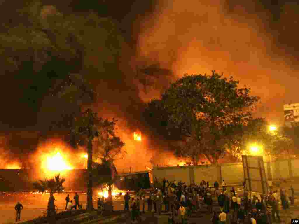 Protesters gather around the burning headquarters of the ruling National Democratic Party (NDP) in central Cairo.