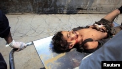 A boy injured by the suicide bomb attack in Mohmand is assisted after being brought to a Peshawar hospital on July 9.