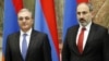 Armenian Prime Minister Nikol Pashinian (right) and then-Foreign Minister Zohrab Mnatsakanian attend an event in Yerevan in March 2019.