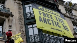 Greenpeace activists in Paris demonstrate in support of their colleagues in custody in Russia on October 9.