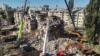 Rescuers conduct a search and rescue operation in and around a residential building heavily damaged during a large-scale Russian attack on Kyiv on August 28.