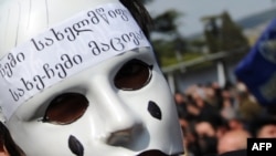 A masked activist at an anti-Saakashvili rally in front of the parliament building in Tbilisi.