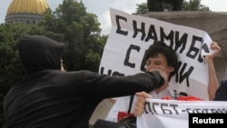 A man attacks a gay rights activist during an unsanctioned gay pride parade in St. Petersburg in June.