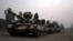 FILE: Pakistani army tanks form a column during a ground military operation in Miran Shah, the main town in North Waziristan.