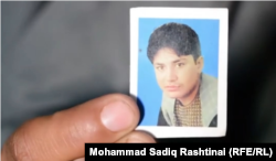 Bibi Gul shows the photo of her slain husband Hashmat.