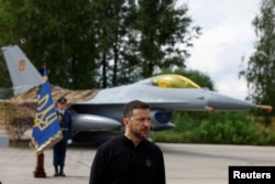 Президент Украины Владимир Зеленский выступает в День военно-воздушных сил на фоне истребителя F-16, август 2024 года