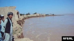 Village elder Hadji Khaleq inspects the ruins of a home in Yaz Ariq Dinar destroyed by the advancing Amu Darya river