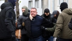 Ukrainian Security Service officers detain Major General Valeriy Shaytanov on suspicion of high treason and terrorism in Kyiv on April 14. 