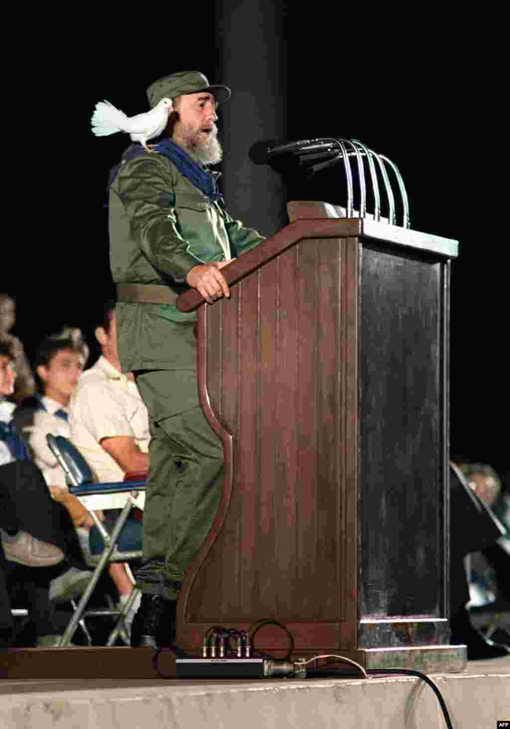 A dove rests on Castro's shoulders as he addresses Cuban youth in 1989 during celebrations marking the 30th anniversary of the country's communist revolution.&nbsp;