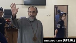 Armenia - Archbishop Mikayel Ajapahian greets supporters during his trial in Yerevan, August 28, 2025.
