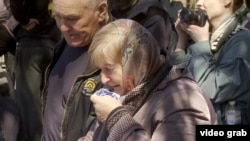 Relatives mourn victims of a deadly Russian missile strike on Sumy at a funeral service on April 15. 