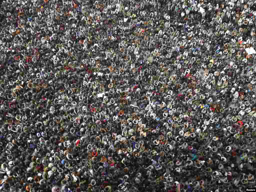 Opposition supporters listen to Egyptian-born cleric Sheikh Yusuf al-Qaradawi before Friday Prayers in Tahrir Square.