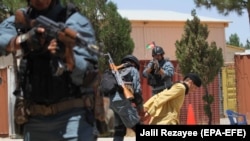 FILE: Afghan police officers show their counterterrorism skills during a training session in Gozara district of Herat on July 21.