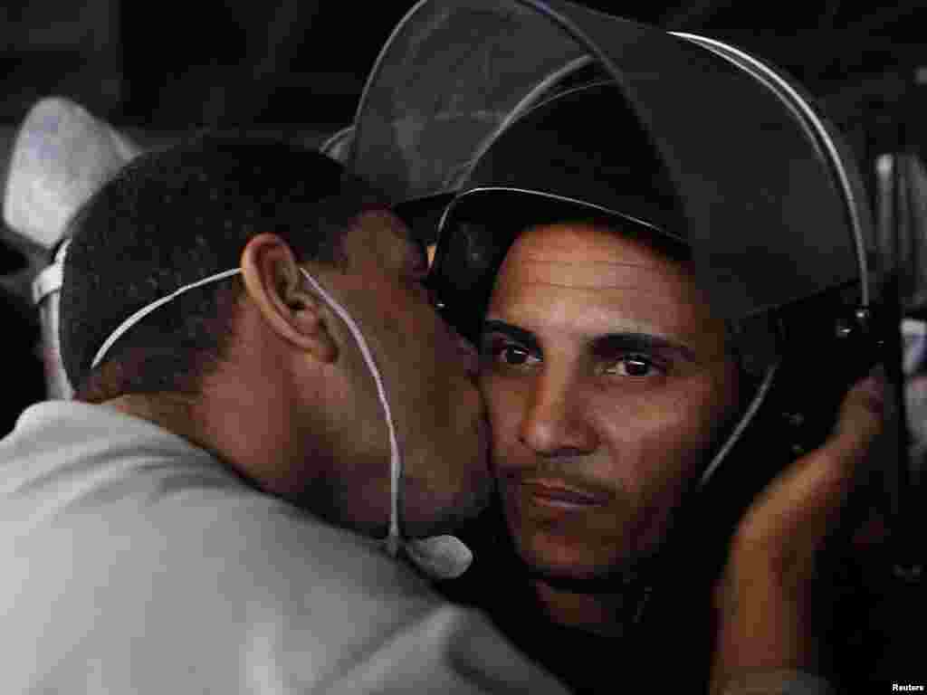 A protester kisses a police officer during a demonstration in Cairo on January 28.