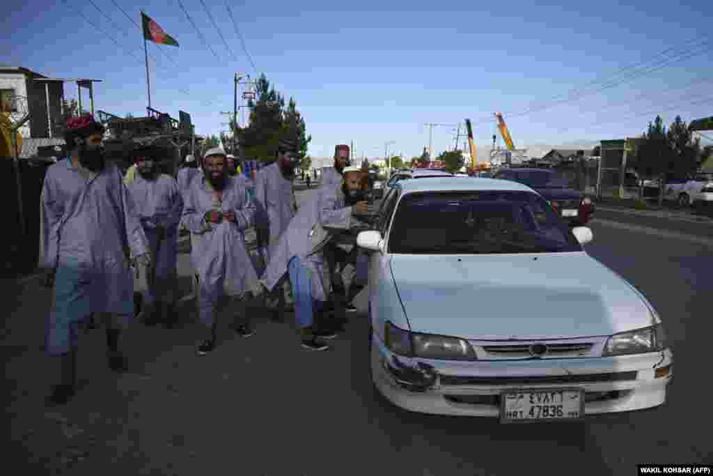 Former Taliban prisoners stop a taxi in the Afghan capital, Kabul, on May 26 -- a day after their release from Bagram prison.