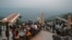 People flock to a restaurant on Margalla Hills in Islamabad on August 10 after the government announced it would be lifting most of the country's remaining coronavirus restrictions.