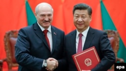 Chinese President Xi Jinping (right) shakes hands with Alyaksandr Lukashenka at a signing ceremony during the Belarusian leader's visit to Beijing in 2016. 