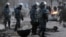 Riot police patrol the Kazakh town of Zhanaozen shortly after violence claimed the lives of at least 16 striking oil workers.