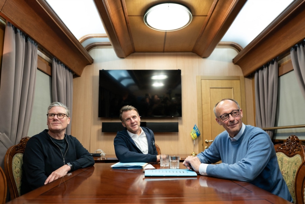 British Prime Minister Keir Starmer (L), French President Emmanuel Macron (C) and German Chancellor Friedrich Merz (R) pose on board a train to Kyiv, in Shegyni, Ukraine, on May 9, 2025.