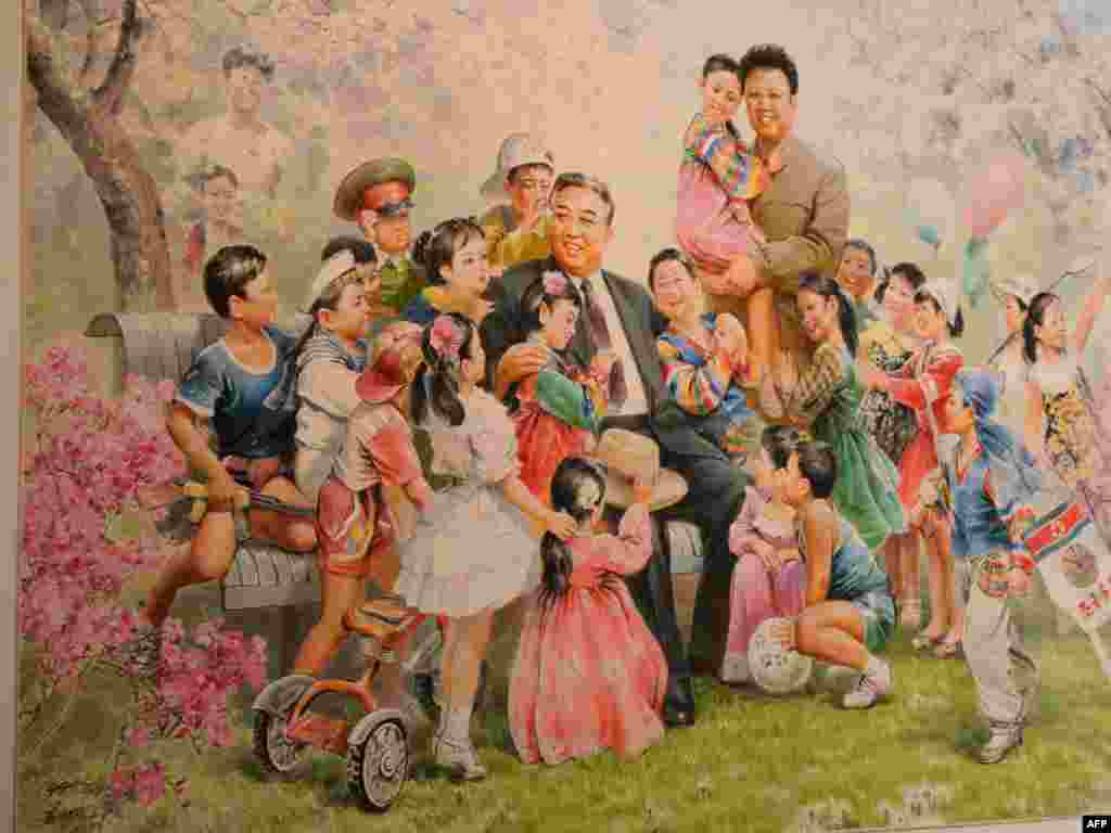 A painting featuring North Korean leaders Kim Il Sung (seated) and Kim Jong Il is on display during the opening of of Democratic People's Republic of North Korea state art exhibition "Flowers of Kim Il Sung" in Vienna in May 2010.