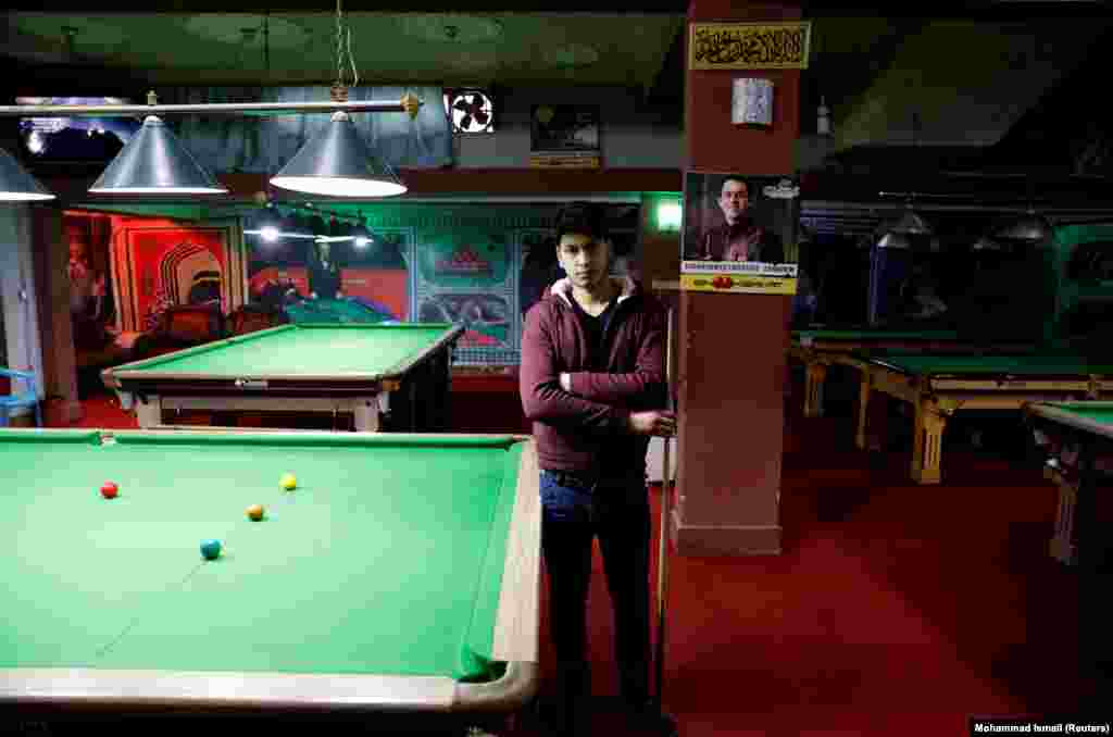 Farzad Aslami, 18, at a snooker club in Kabul. "We want peace for the sake of our country's welfare. We don't want any more suicide attacks and explosions."