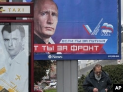 Election billboards for Vladimir Putin (right) and Mikhail Prokhorov in St. Petersburg in September. Some believe Prokhorov has been deliberately deployed by the Kremlin to bolster Putin’s reelection.