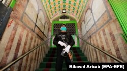A Pakistani security official stands guard outside a mosque that was closed for weekly Friday prayers in the northwestern city of Peshawar on April 10.