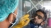 A paramedic wearing protective gloves takes a nose-swab sample to be tested for the coronavirus in Karachi.