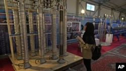 A student looks at Iran's domestically built centrifuges in an exhibition in Tehran, Feb. 8, 2023