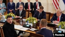 Ukrajinski predsednik Volodimir Zelenski za stolom s predsednikom SAD Donaldom Trampom, francuskim predsednikom Emanuelom Makronom, britanskim premijerom Kirom Starmerom i finskim predsednikom Aleksandrom Stubom (okrenut leđima) na razgovorima u Beloj kući 18. avgusta 2025.