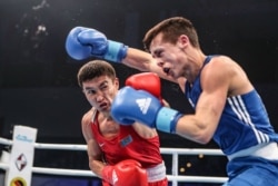 Gazagystanly boksçy Kaýrat Eraliýew (gyzyl eşikde) Germaniýanyň Gamburg şäherinde geçýän dünýä ýaryşynda.