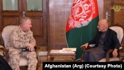 FILE: U.S. Central Command’s General Kenneth McKenzie (L) with the Afghan Afghan President Mohammad Ashraf Ghani in Kabul in January.