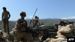 FILE: U.S. soldiers take up positions during an ongoing an operation against Islamic State (IS) militants in Achin district of Nangarhar Province in April.