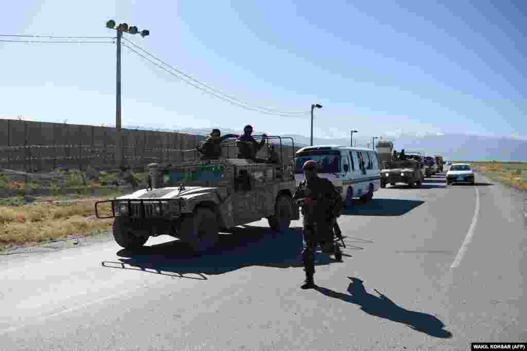 Afghan National Army soldiers escort a convoy of Taliban prisoners during their release from Bagram prison, outside the U.S. military base in Bagram, some 50 kilometers north of Kabul.