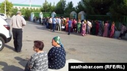 Aşgabat şäheriniň Berkararlyk etrabynyň pasport bölüminiň öňünde nobata duran adamlar. Illýustrasiýa suraty. 30-njy iýul, 2013-nji ýyl. 