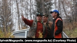 Panayot Zakharopulo (left) stands with co-workers in front of his Niva at Ile-Alatau National Park in October 2009. Zakharopulo had maintained an uncompromising stance against unlicensed hunting in the park.