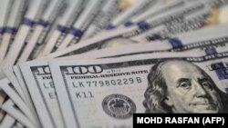 This photo illustration shows US dollar notes at a foreign currency dealer in Ampang on August 14, 2015.