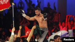 Afghan-German World Boxing Union champion Hamid Rahimi celebrates his victory over Said Mbelwa (not pictured) of Tanzania after their World Boxing Organization intercontinental middleweight fight in Kabul on October 30.