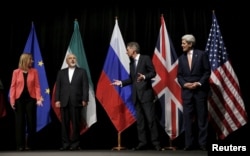 Top diplomats of JCPOA parties prepare for a group photo after clinching a landmark nuclear deal in Vienna on July 14, 2015.