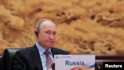 Russian President Vladimir Putin attends a roundtable session at the Belt And Road Forum in Beijing on May 15.