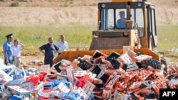 Russia -- A worker uses a bulldozer to crush crates of peaches smuggled from the EU outside the city of Novozybkov, August 7, 2015.