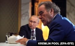 Oliver Stone (right) interviews Russian President Vladimir Putin for his Revealing Ukraine documentary at the Kremlin in Moscow in July 2019.