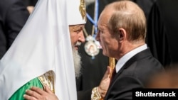 Patriarch Kirill (left) and Russian President Vladimir Putin (right) -- working together?