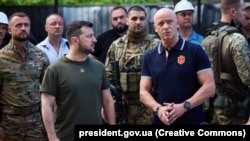 Odesa Mayor Hennadiy Trukhanov (right), standing with President Volodymyr Zelenskyy outside an Odesa apartment building damaged by a Russian missile in 2022