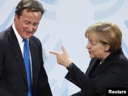 Dejvid Kamerun i Angela Merkel