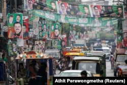A street is decorated with flags and banners of political parties ahead of general elections in Rawalpindi on July 23.