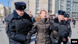 Russian police detain a protester ahead of an opposition rally in central Moscow.