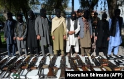 Alleged Taliban fighters and other militants stand handcuffed while being presented to the media at police headquarters in Jalalabad, eastern Afghanistan, earlier this year.