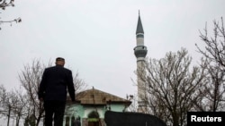 A Crimean Tatar arrives for Friday Prayers at the Khan Chair mosque in Bakhchysaray.